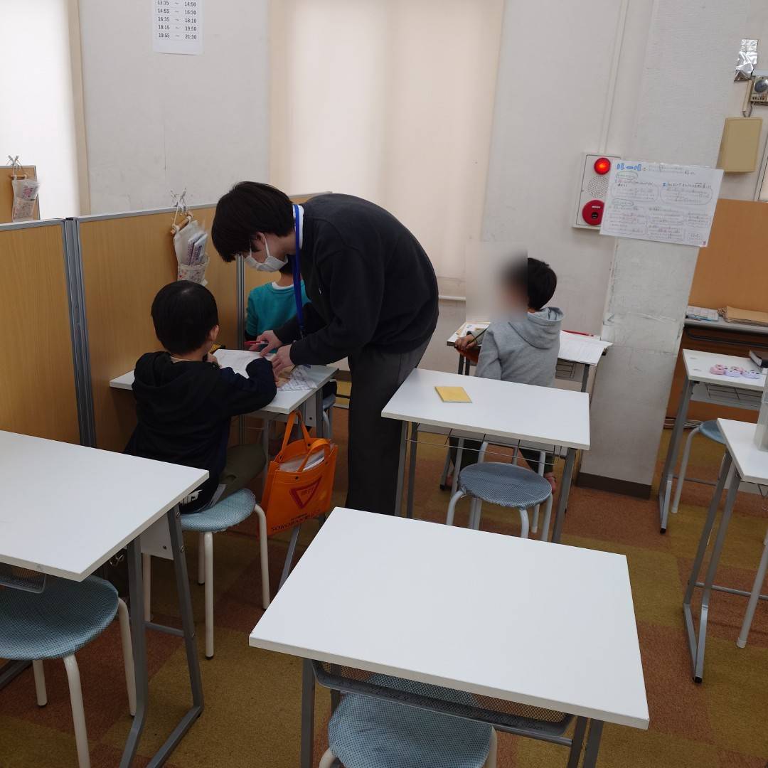 そろばん教室で丁寧に指導する様子